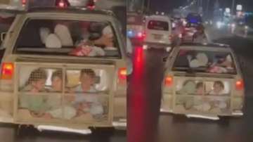 Kids crammed into cage attached to a car in Pakistan’s Karachi