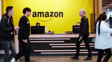 Employees walk through a lobby at Amazon's headquarters 