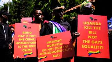 Activists hold placards during their picket against Uganda's anti-homosexuality bill at the Ugandan High Commission in Pretoria