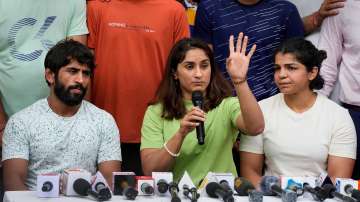 Wrestlers Bajrang Punia, Vinesh Phogat (Centre) and Sakshii Malikk address the media during their protest at Jantar Mantar, in New Delhi
