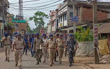 Police personnel keep a vigil during a clash between supporters of Indian Secular Front (ISF) and Trinamool Congress (TMC) in Bhangore area ahead of the upcoming Panchayat poll