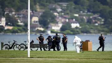 Security forces examine the scene of knife attack in Annecy, French Alps