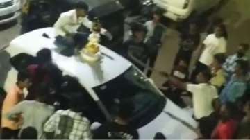 Man cuts birthday cake with sword on car in Pune