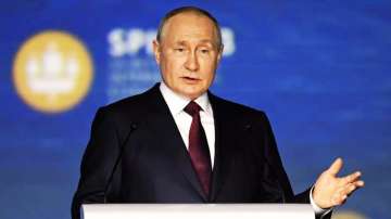 Russian President Vladimir Putin gestures as he addresses the audience during the plenary session of the St. Petersburg International Economic Forum.