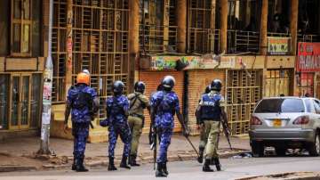 Ugandan security forces patrol on a street in Kampala