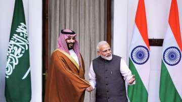 Indian Prime Minister Narendra Modi, right, shakes hand with Saudi Crown Prince Mohammed bin Salman before the start of their meeting in New Delhi.