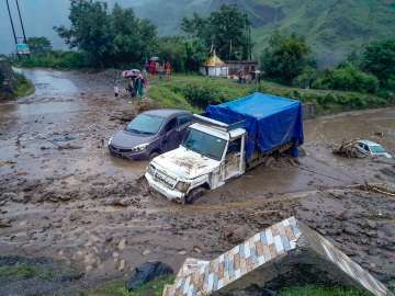 Shimla: Vehicles stuck in debris after a cloudburst at Rohru area in Shimla district, Saturday