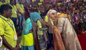 PM Modi felicitating workers at the ITPO complex