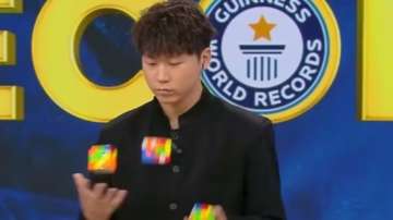 Chinese man creates Guinness World Record by solving three Rubik's Cubes while juggling them.