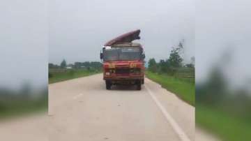 Maharashtra state bus with detached roof travels on road