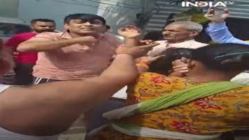 Delhi couple who assaulted their minor domestic help being manhandled by a mob. 