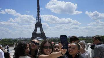 Tourists at Eiffel Tower in Paris, France. 