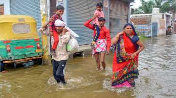 Residents shift to a safer place from the flooded Karhera area during monsoon season in Ghaziabad.