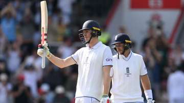 Zak Crawley and Joe Root during Day 2 at Old Trafford