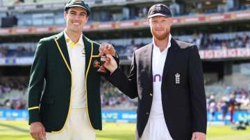 Ben Stokes and Pat Cummins pose with the urn for the cameras