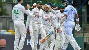 Pakistan players celebrating in a huddle
