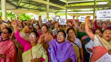Women protest against the recent videos showing two women being paraded naked by a mob in violence-hit Manipur.