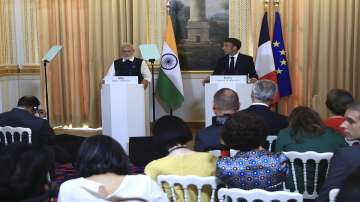 PM Modi and French President Emmanuel Macron attend a joint press conference at the Elysee Palace in Paris