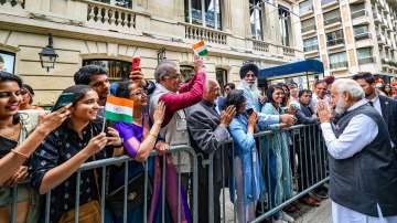 PM Modi being welcomed by Indian community members upon his arrival in Paris, France.