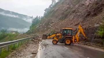 Heavy machinery being used to clear Rishikesh-Badrinath National Highway blocked with boulders after a rain-triggered landslide, in Rudraprayag district.