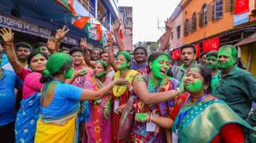 TMC supporters celebrate the party's lead during the counting of votes of West Bengal panchayat polls, in Howrah
