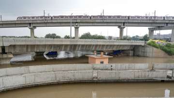 A Delhi Metro train passes above the floodwaters of the swollen Yamuna river at Mayur Vihar, in New Delhi.