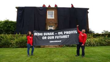 Greenpeace demonstrators drape Rishi Sunak's house in black