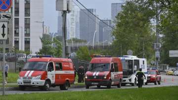Police and emergency vehicles parked at the side of the wreckage of the drone fell near the Karamyshevskaya embankment to the after a reported drone attack in Moscow.