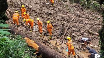 NDRF personnel carry out rescue, relief work following a landslide after heavy rains in Shimla