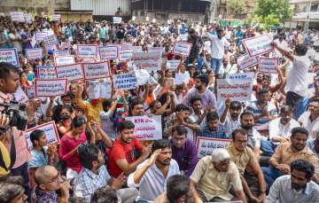 Applicants of Telangana State Public Service Commission (TSPSC) Group 2 exam stage a protest demanding to postpone the exam, in Hyderabad