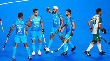 Indian players celebrate after scoring a goal against Pakistan