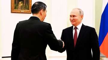 Russian President Vladimir Putin and Chinese Defense Minister Gen. Li Shangfu shake hands during their meeting at the Kremlin in Moscow, Russia on April 16, 2023