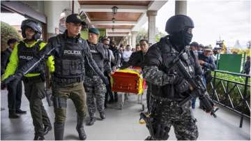 Villavicencio's remains being carried by the Ecuadorian police.