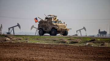 US military vehicle on patrol in countryside near town of Qamishli, Syria