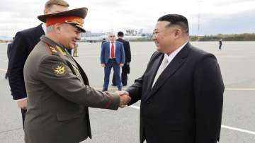 North Korean leader Kim Jong Un (right) is greeted by Russian Defense Minister Sergei Shoigu (left)