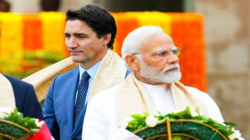 Canada's Prime Minister Justin Trudeau (left) walks past Indian Prime Minister Narendra Modi