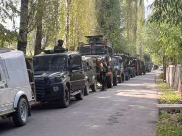 Security personnel cordon off the area after 3 Army men were killed in a gunfight with terrorists at Kokernag area, in Anantnag district