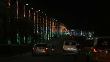 Vehicles move on a road decorated in tri-colours near Terminal 3 of Indira Gandhi Internation Airport ahead of the G20 Summit, in New Delhi