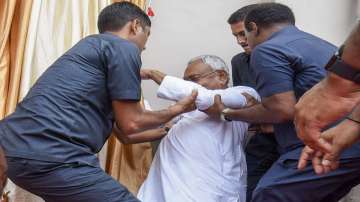 Bihar Chief Minister Nitish Kumar being assisted after he lost his balance during the inauguration of the renovated Wheeler Senate House of Patna University, in Patna, Tuesday, Sept. 5, 2023.