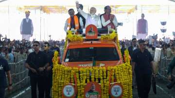 Prime Minister Narendra Modi waves at supporters as he arrives to address BJPs Karyakarta Mahakumbh, in Bhopal. Madhya Pradesh Chief Minister Shivraj Singh Chouhan and State BJP President VD Sharma are also seen.