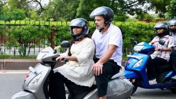Congress leader Rahul Gandhi rides pillion on a student's scooter in Jaipur  