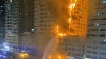 In this image made from the Ajman Police twitter, fire fighters try to extinguish a residential tower which caught fire early morning on Tuesday, June 27, 2023, in Ajman, United Arab Emirates.