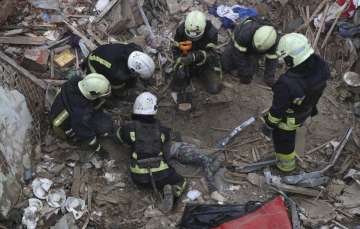 Authorities pulling the body of the boy from the rubble in Ukraine's Kharkiv