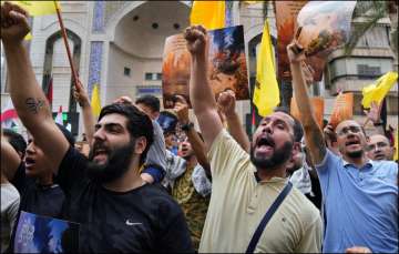 Hezbollah supporters raise slogans in solidarity with Palestine after Hamas launched an attack in Israel