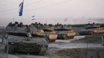 Israeli tanks head towards the Gaza Strip border in southern Israel.