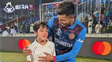 Mujeeb Ur Rahman with a young fan.