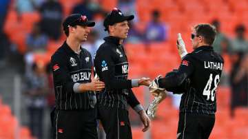 Mitchell Santner celebrating a dismissal with teammates Tom Latham and Will Young.
