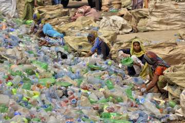 Pakistani woman collecting garbage.