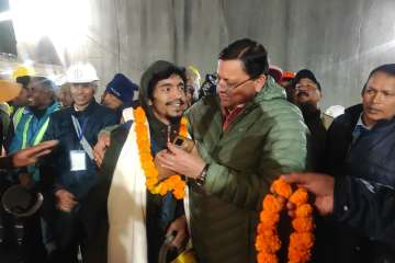Uttarakhand Chief Minister Pushkar Singh Dhami greets rescued workers coming out of the collapsed Silkyara Tunnel.