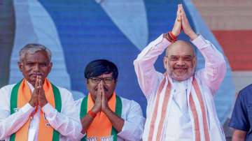 Union Home Minister Amit Shah with BJP leaders waves to the crowd during a public meeting ahead of Telangana Assembly elections.